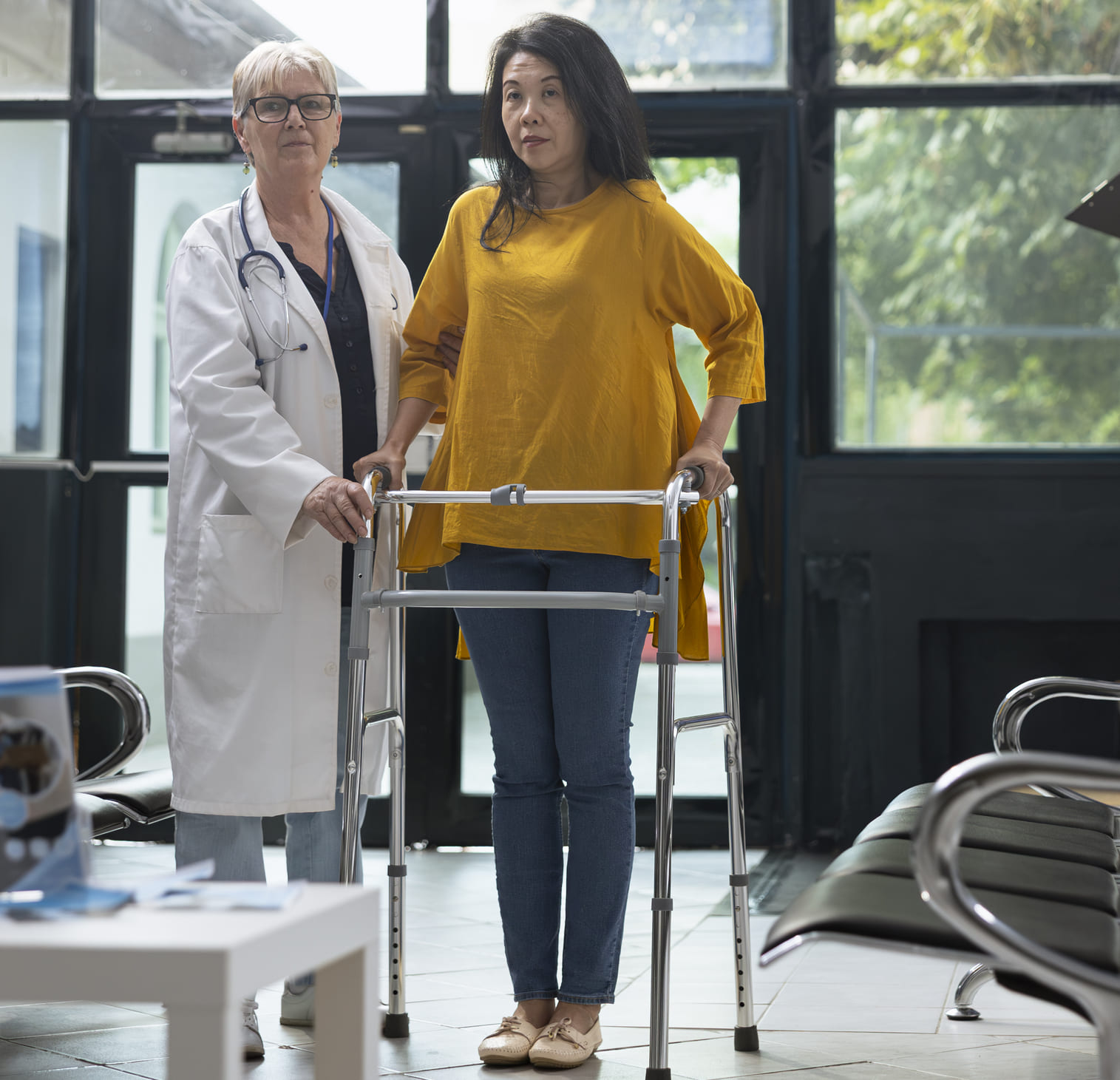 Woman using walking frame during rehabilitation healing process.